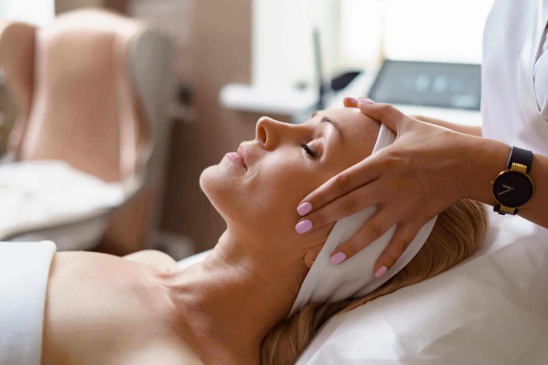woman getting a massage treatment on her head at a spa