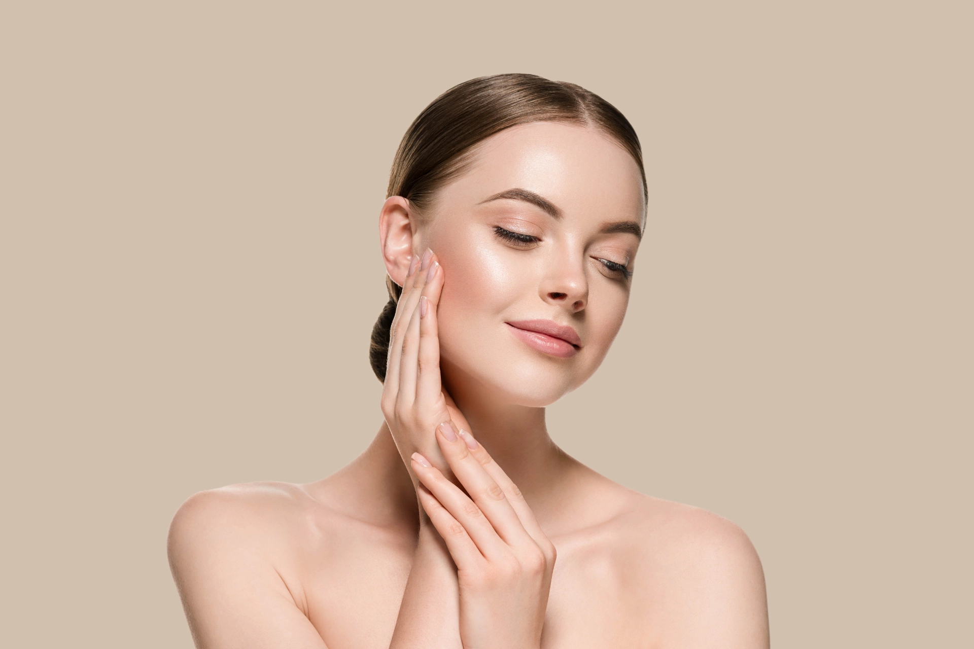 woman with smooth skin feeling her face